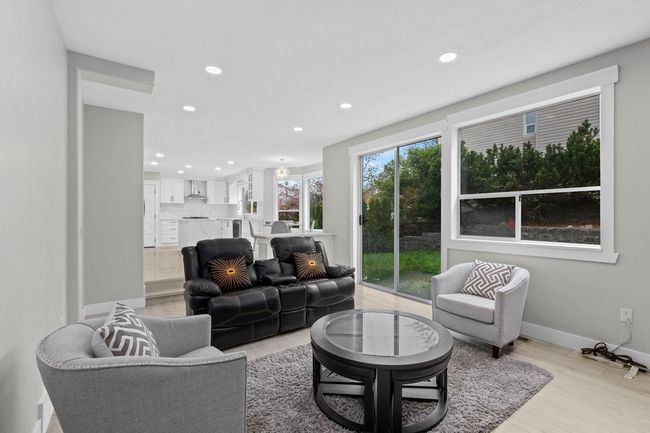 Living room featuring light wood-style floors, baseboards, and recessed lighting | Image 15