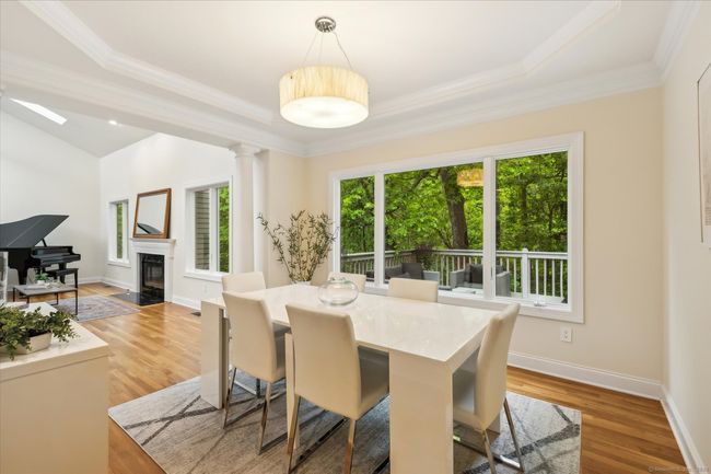 Dining room with hardwood floors and awesome nature views. | Image 12