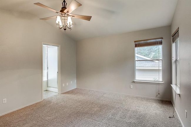 Unfurnished room with ceiling fan, carpet flooring, vaulted ceiling, and baseboards | Image 19