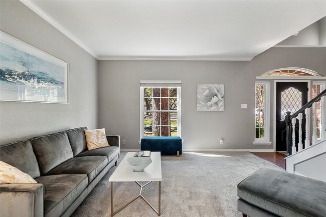 Living area with carpet, crown molding, and baseboards | Image 5