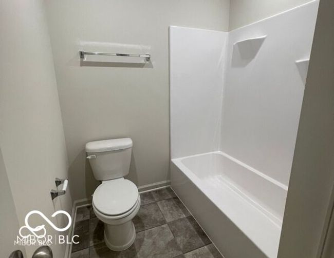full bathroom with toilet and baseboards | Image 18