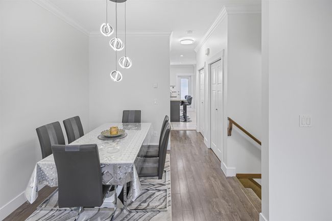 Dining space with ornamental molding and wood finished floors | Image 6