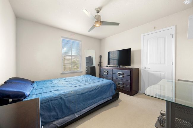 Upstairs you will also find two perfectly sized secondary bedrooms with cozy carpeting and closet storage. This room comes with a modern ceiling fan, along with the primary bedroom. | Image 21