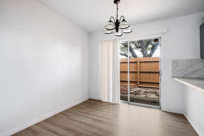 Unfurnished dining area with light hardwood / wood-style floors and a chandelier | Image 10