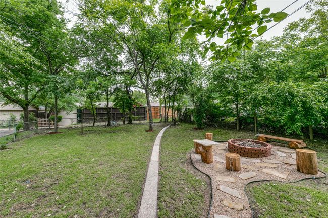 View of yard with a fire pit | Image 19