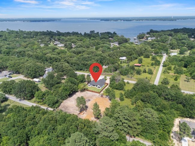 Aerial view of property's location featuring a nearby body of water and a forest | Image 36