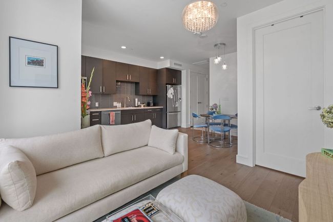 Living room featuring wood finished floors, wet bar, a chandelier, and recessed lighting | Image 13