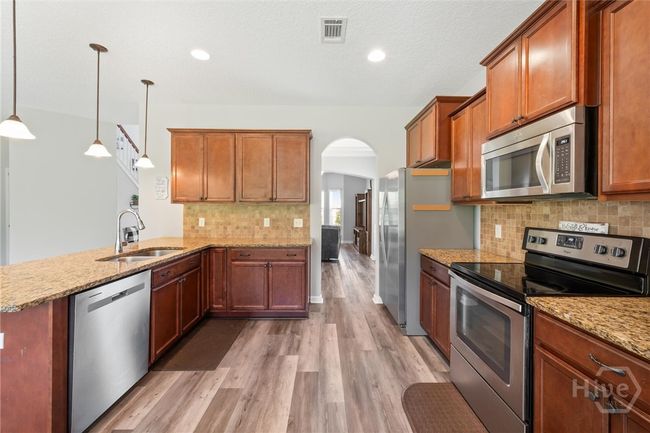 Abundant cabinetry and full tile backsplash. | Image 12