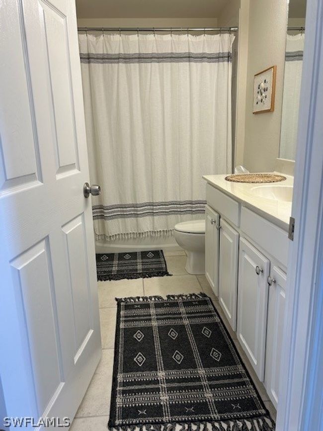 Bathroom featuring tile floors, vanity, and toilet | Image 22