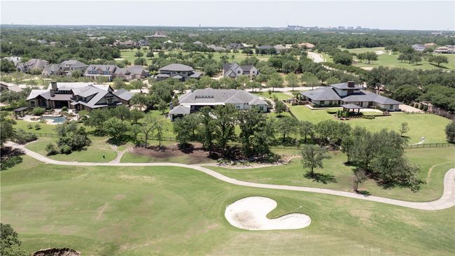 Aerial overview of property's location featuring nearby suburban area, a golf club, and a tree filled landscape | Image 32