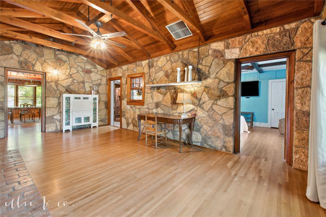Living room featuring this darling suspended shelf and beautiful rock walls. | Image 9