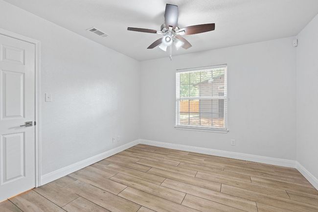Empty room featuring ceiling fan and light wood-style flooring | Image 16