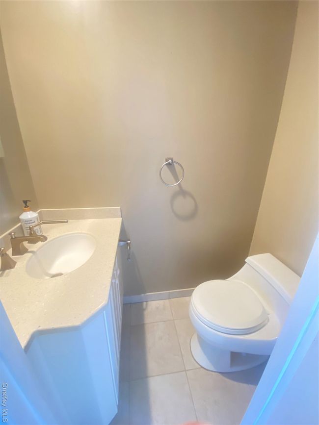 Full bath featuring shower / bath combination with glass door, vanity, light tile patterned floors, and recessed lighting | Image 18
