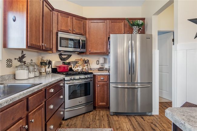 Stainless appliances give a clean, sleek look to the kitchen in this custom built home - easy care flooring throughout! | Image 20