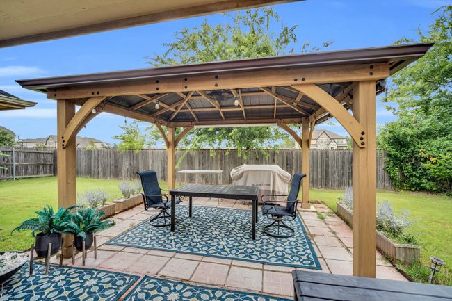 Fenced backyard with a gazebo and a patio | Image 33