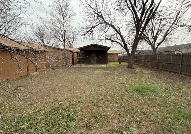 View of yard with an outdoor structure and fence | Image 12