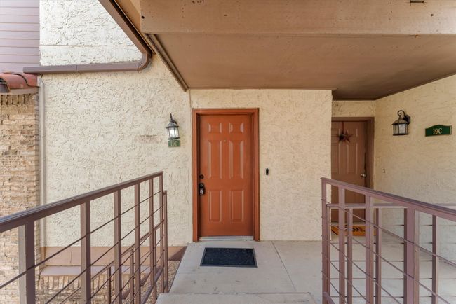Doorway to property featuring stucco siding | Image 5