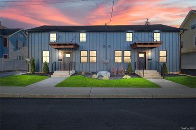 Modern farmhouse style home featuring a lawn | Image 1