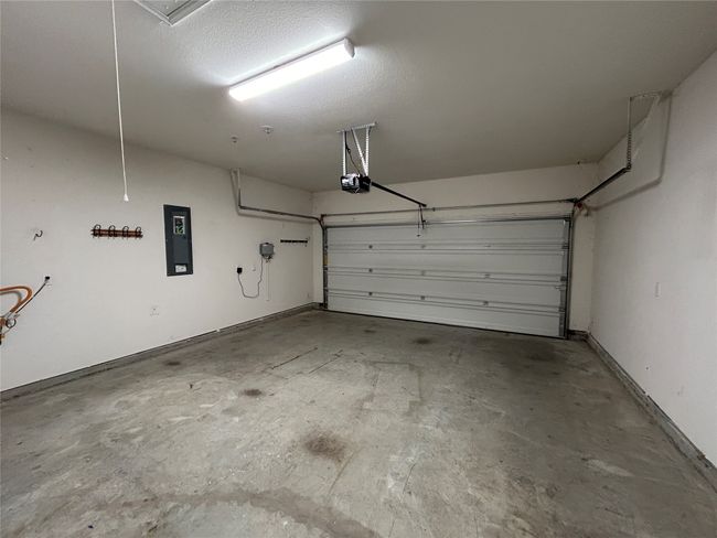 Garage with a garage door opener and electric panel | Image 26