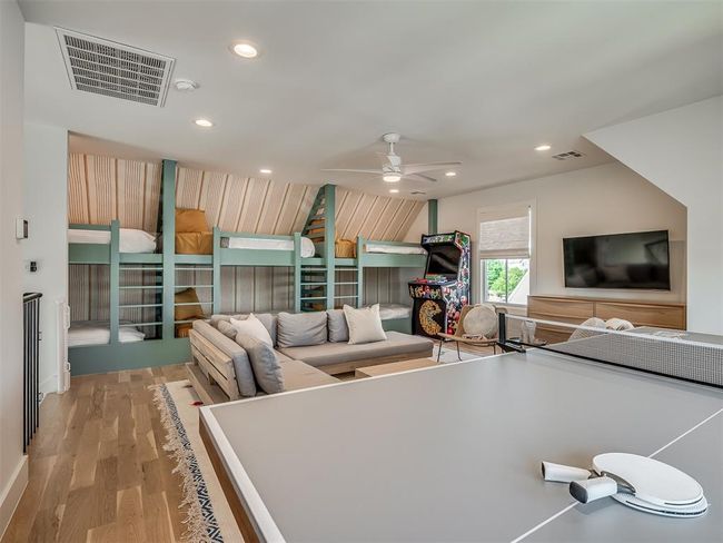 Recreation room with wood finished floors, ceiling fan, and recessed lighting | Image 35