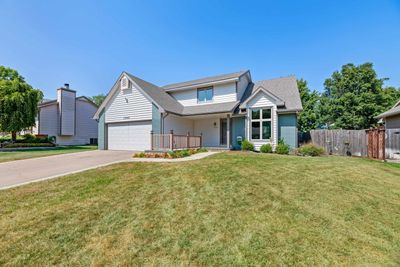 View of front of house featuring a front lawn and a garage | Image 2