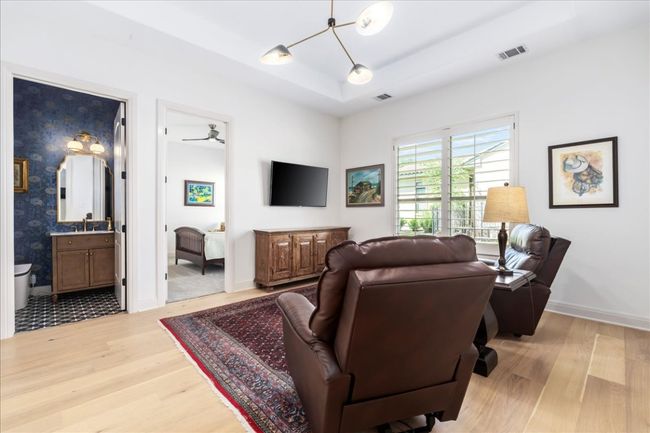 Living area featuring light wood-style flooring, a raised ceiling, and baseboards | Image 23