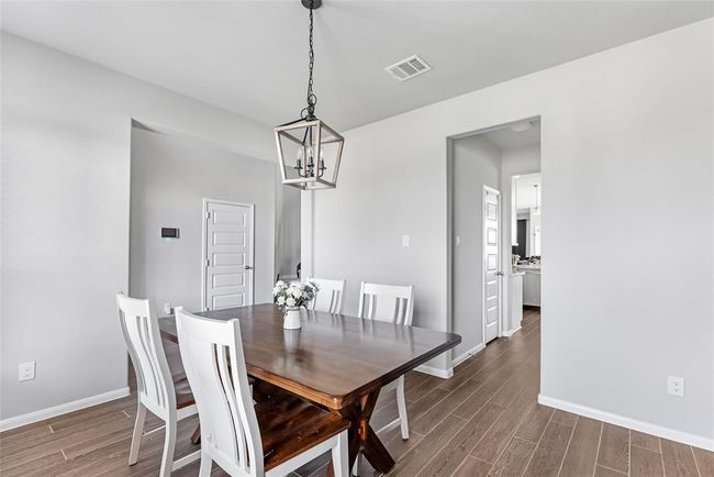 Small hallway leads from dining room into kitchen. In the hallway is a half bath and a pantry. | Image 8