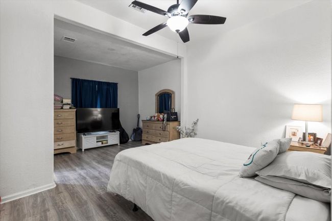 Bedroom featuring wood finished floors and a ceiling fan | Image 8