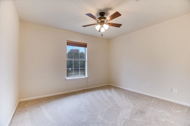 Spare room with carpet floors, baseboards, and ceiling fan | Image 13
