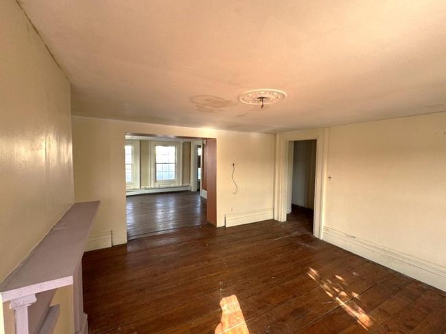Formal dining room with baseboards, baseboard heating, and dark wood-type flooring | Image 8
