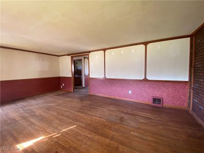 Unfurnished room featuring dark wood-type flooring and crown molding | Image 3