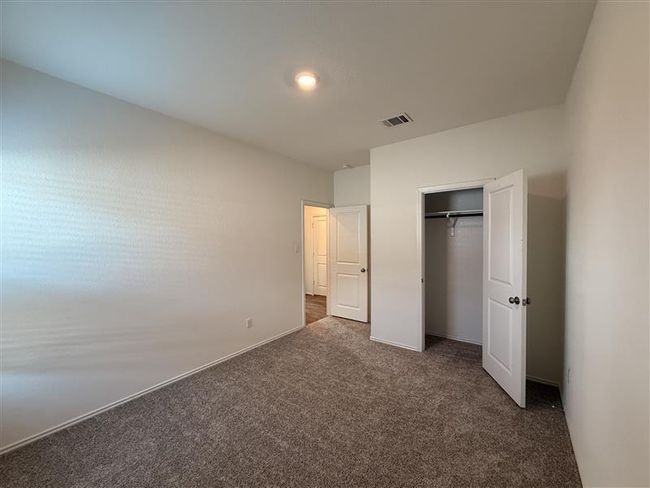 Unfurnished bedroom featuring carpet flooring and a closet | Image 8