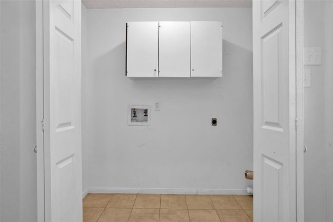 Utility closet located right off kitchen at back door. | Image 18