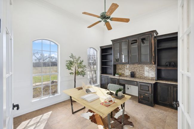 Office featuring crown molding, ceiling fan, and a high ceiling | Image 8