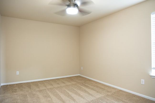 Spare room featuring carpet, ceiling fan, and baseboards | Image 23