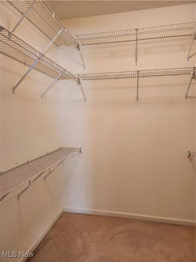 Master Bedroom's spacious walk-in closet with shelving | Image 28