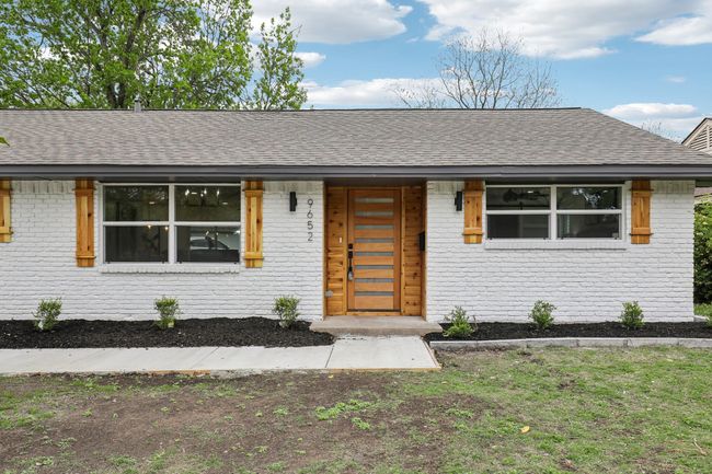 View of front facade with brick siding and a shingled roof | Image 27