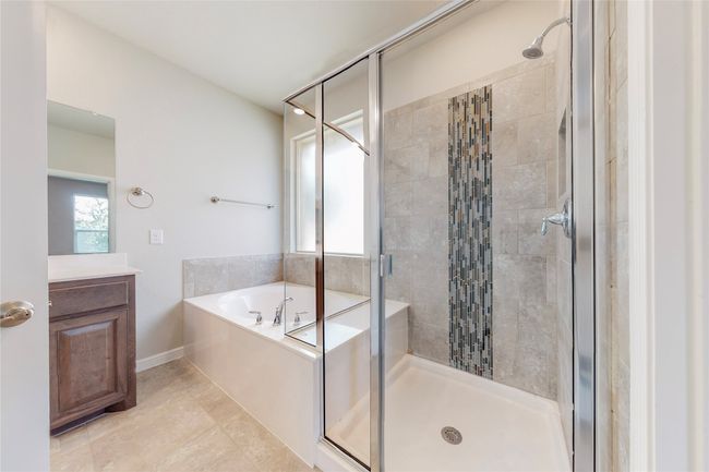 Full bathroom featuring a garden tub, a stall shower, baseboards, vanity, and tile patterned flooring | Image 21