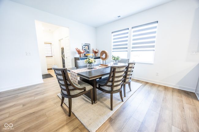 dining space with light wood-type flooring and baseboards | Image 11