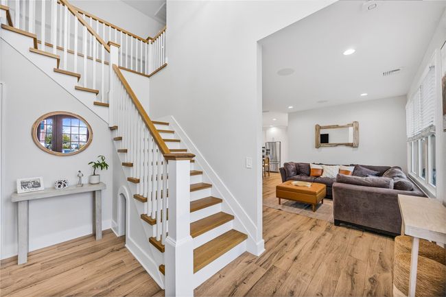 Stairs with wood finished floors, recessed lighting, baseboards, and visible vents | Image 5