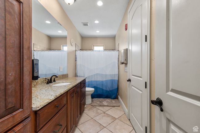 Bathroom with tile patterned flooring, recessed lighting, vanity, and visible vents | Image 39