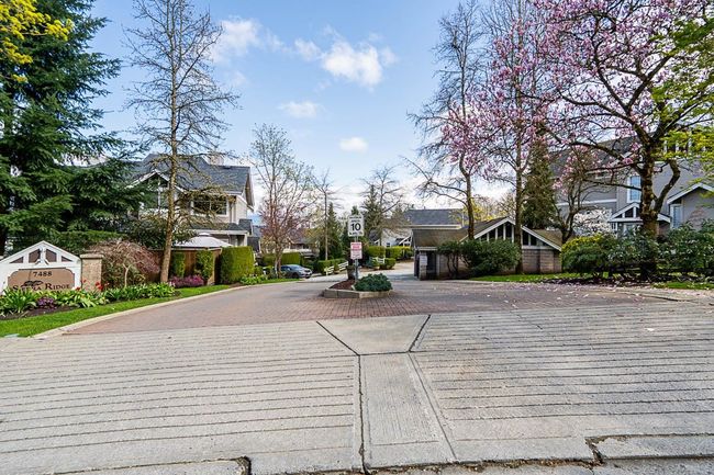 View of street with curbs, a residential view, and traffic signs | Image 35