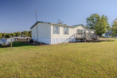 Back of house featuring a wooden deck and a lawn | Image 3