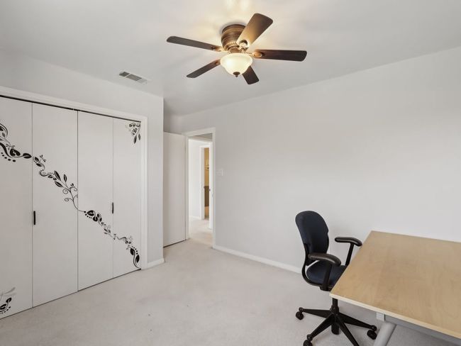 Unfurnished office with light colored carpet, ceiling fan, baseboards, and visible vents | Image 28