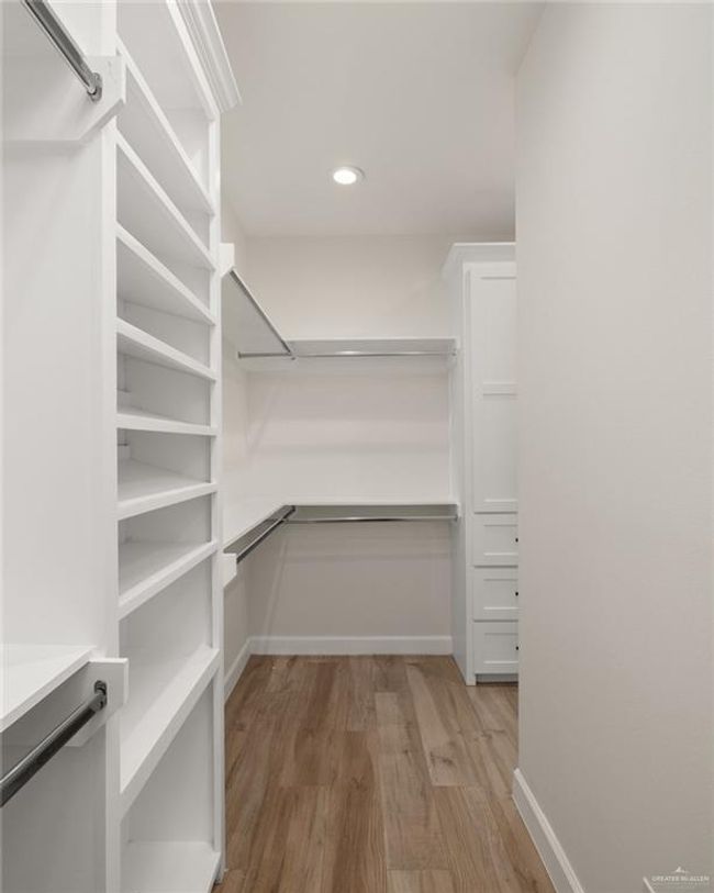 Spacious closet with wood finished floors | Image 8
