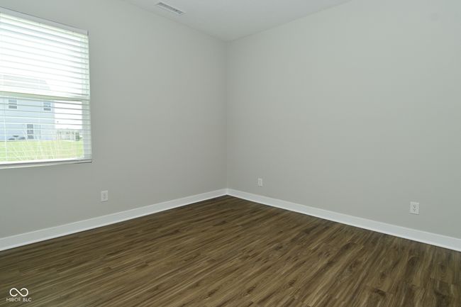 empty room featuring dark wood-style flooring, baseboards, and visible vents | Image 17