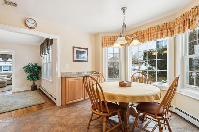 Dining area with a baseboard heating unit | Image 9