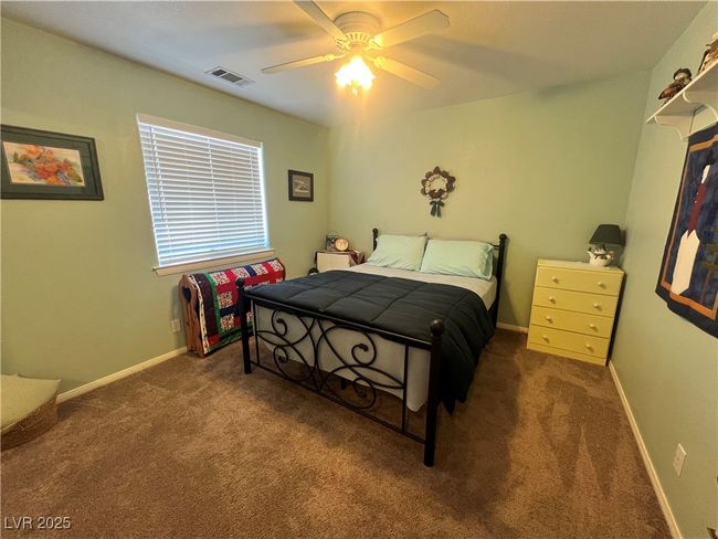 Bedroom with carpet and a ceiling fan | Image 49