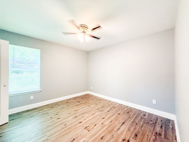 Unfurnished room with wood finished floors and ceiling fan | Image 8