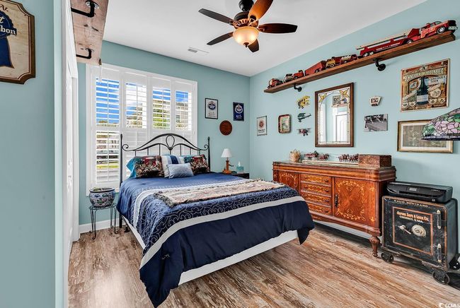 Bedroom with baseboards, visible vents, ceiling fan, and light wood-style flooring | Image 20
